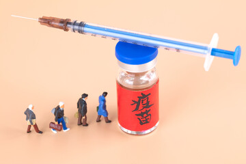 A doll model lining up for a vaccine