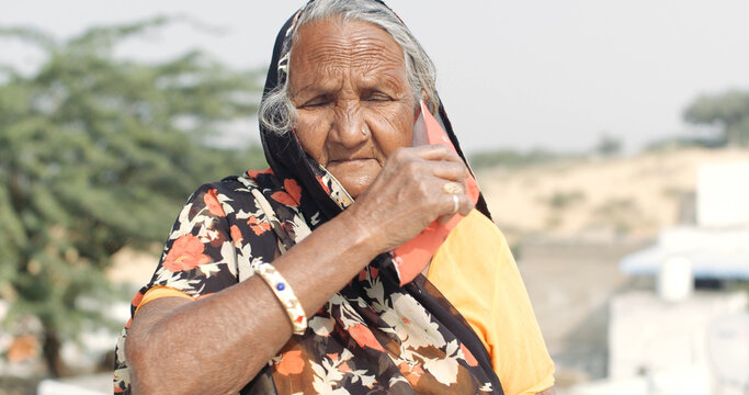 Old Indian Woman Wearing A Traditional Sari Outdoors