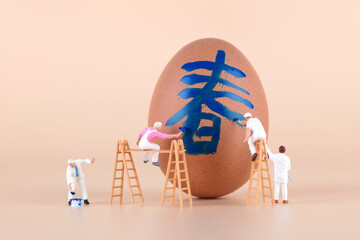 The painter paints a spring character on the egg