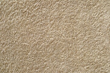 The texture of a sand-colored terry cotton towel