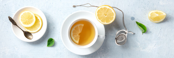 Lemon tea in a cup, overhead flat panorama. Organic lemons, shot from above. Healthy detox citrus drink panoramic header, natural remedy