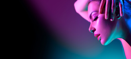 Femme modèle haute couture en néons lumineux colorés qui pose en studio, boîte de nuit. Portrait de belle fille en UV. Maquillage coloré de conception d& 39 art. Sur fond vif coloré, art design