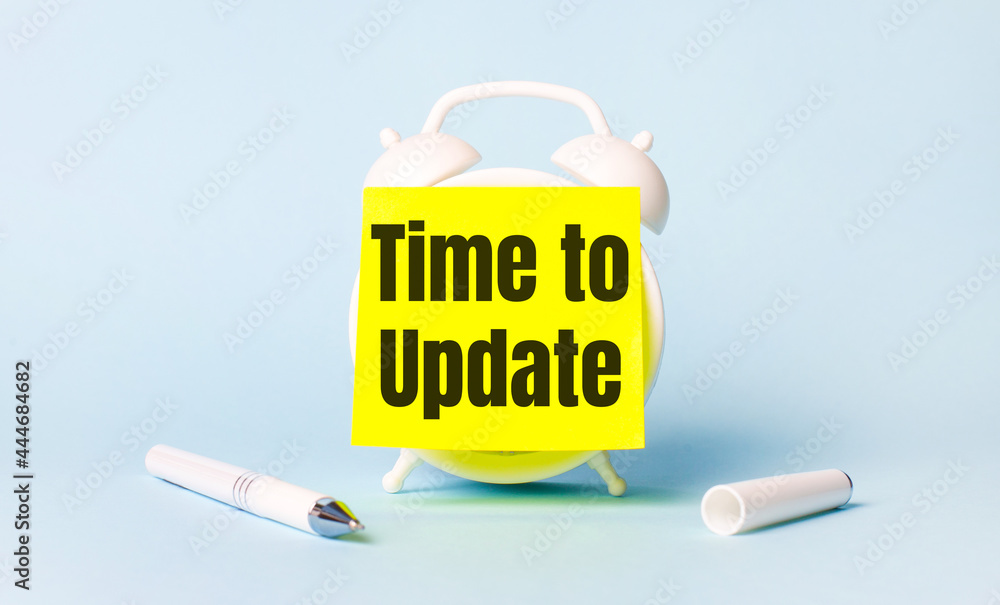 Poster on a light blue background - a white handle and an alarm clock with a bright yellow sticker glued to