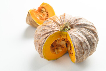 Close up of cutting organic pumpkin on white background