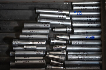Round metal samples for strength tests and metal alloy composition in factory laboratory, top view.