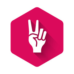 White Hand showing two finger icon isolated with long shadow background. Hand gesture V sign for victory or peace. Pink hexagon button. Vector