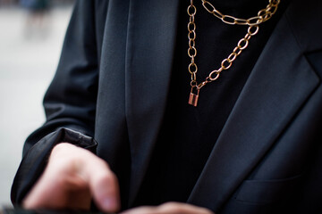 golden pendant on the neck of a man or boy. Men's jewelry fashion trend. luxury.