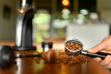 The barista preparing various tools to make espresso.