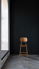 wooden bar stool in the interior against the background of a dark wall