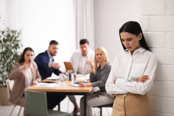 Coworkers bullying their colleague in office, space for text