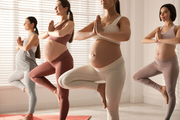 Group of pregnant women practicing yoga in gym, closeup - obrazy, fototapety, plakaty