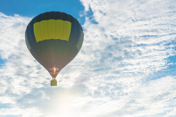 Hot Air Balloon and blue sky white cloud.Blue yellow hot air balloon in the air at summer evening.