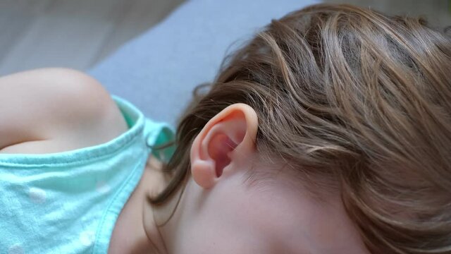 Caucasian Male Applying Drop of Liquid Antibiotic Steroid Medicine into Ear of Young Child
