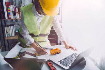 engineer working at a drawings of house in office for discussing. Engineering tools and...