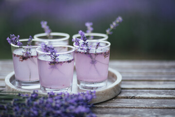 Obraz na płótnie Canvas Fresh lavender lemonade on marble tray standing on wooden table.