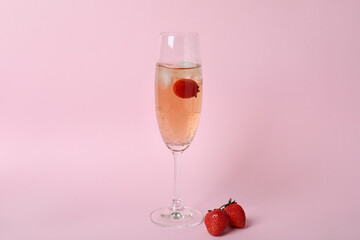 Glass with Rossini cocktail on pink background