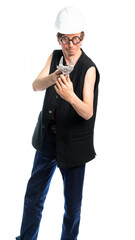 worker in a white helmet and black vest and round glasses. holds an adjustable wrench and looks at us. isolated white background