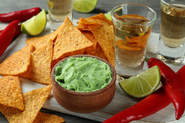 Party concept with tequila, guacamole and chips