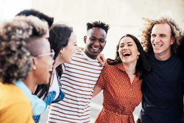 Young happy people laughing together - Multiracial friends group having fun on city street -...