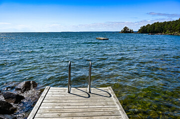Fototapeta na wymiar jetty with bathing ladder in lake Vattern Sweden
