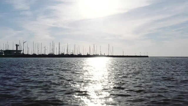 Drone aerial  footage of marina with yachts. Sun reflection on water. Lithuania, Nida.