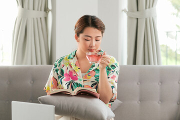 young attractive asian woman who reads a book