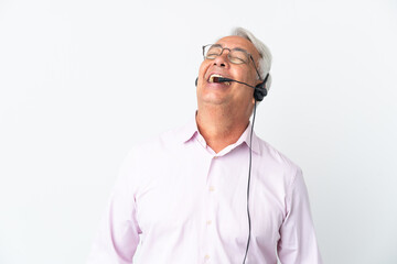 Telemarketer Middle age man working with a headset isolated on white background laughing