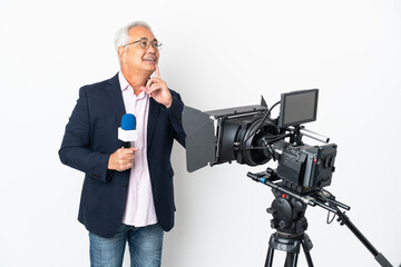 Reporter Middle age Brazilian man holding a microphone and reporting news isolated on white background thinking an idea while looking up