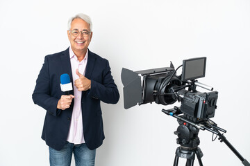 Reporter Middle age Brazilian man holding a microphone and reporting news isolated on white background giving a thumbs up gesture