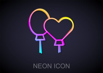 Glowing neon line Balloons with ribbon icon isolated on black background. Vector