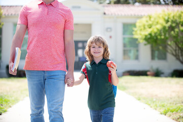 childhood and parenthood. cropped parent leads child boy in first grade.