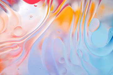 Close-up of the movement of oil droplets on the water surface. Colorful abstract macro background...