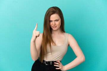 Teenager girl over isolated blue background frustrated and pointing to the front