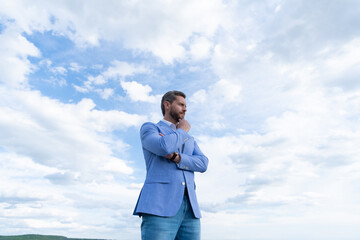 man bride groom on sky background. serious businessman in formalwear. business success.