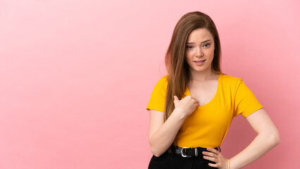 Teenager girl over isolated pink background pointing to oneself