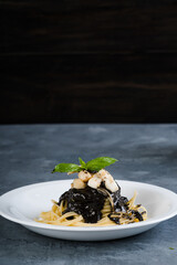 bay scallop and squid in black ink pasta sauce