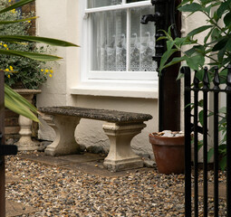 Old stone bench seat under a window