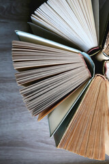 Vintage hardcover books on a wooden table. Top view.