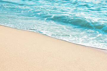 Fototapeta na wymiar Soft blue ocean wave on sandy beach