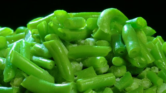 Time lapse of defrosting green vegetables (Snap beans). Close up