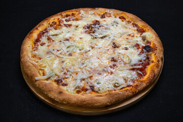 Pizza quatro formaggi with tomato sauce and 4 kinds of cheese on a black background.