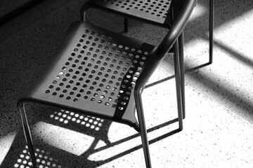 Black plastic chairs close up. Black and white photo. Office background.