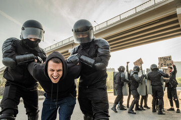 Riot officer stopping protester
