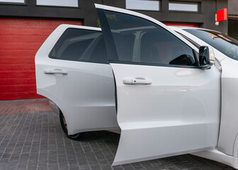 Side view of new white modern car with open doors. Luxury expensive car with open doors. Outdoors
