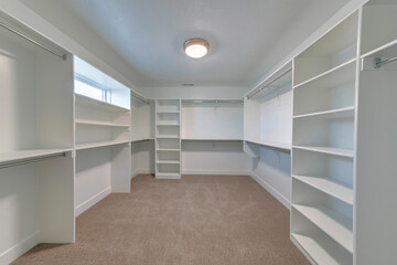 Empty closet of house with shelves and rods for organizing clothes and garments