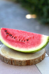 Slice of watermelon, served in a garden. Selective focus.
