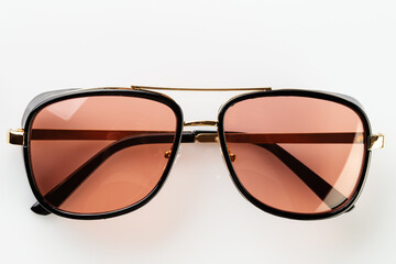 Sunglasses on a white reflective surface. Fashionable, stylish accessories. Use it for a vacation...