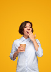 Tired woman with coffee yawning
