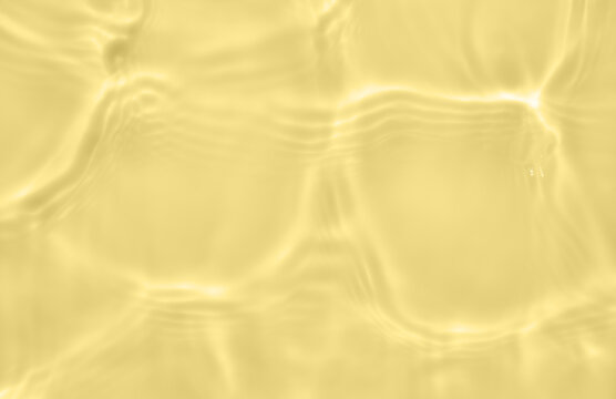 Subtle yellow texture of light-shadow pattern of sunlight reflection from rippled water surface. Beautiful natural pattern with 3D feeling. 
