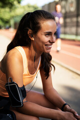 Young sporty woman preparing for the training. Beautiful woman in sportswear working out.